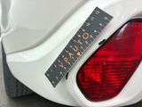 a sticker on the tail light of a white car