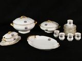a group of porcelain dishes and cups on a black background
