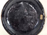 a black bowl with a gold rim sitting on a table