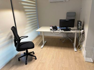 a desk with a chair and a computer on it