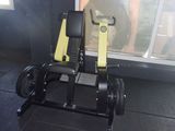 a black and yellow gym equipment sitting on a black floor
