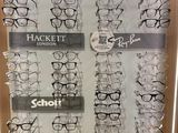 many pairs of glasses on display in a display case