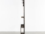 a tall metal pole with a clock on top of it