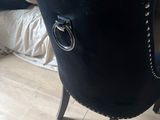 a black chair that has a ring on the back of it