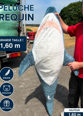 a man standing next to a large shark that is being held by a man