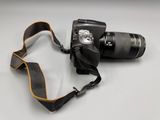 a camera strap attached to a camera on a table
