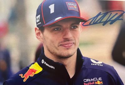 signed photo of a red bull driver in a blue cap