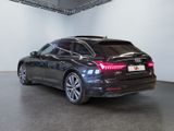 the rear end of a black car parked in a garage
