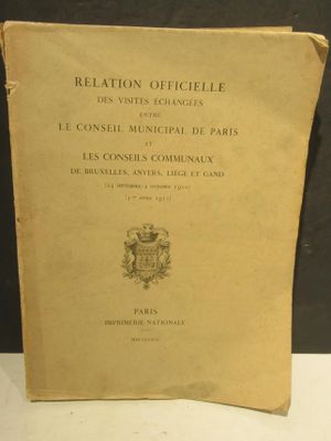 un vieux livre posé sur une table blanche, près d'un mur noir