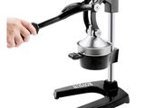someone is using a manual juicer to make a smoothie