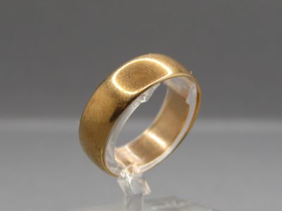 an image of a close up of a gold ring on a clear surface