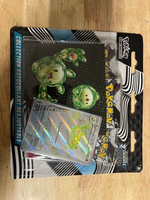 a box of pokemon trading cards on a wooden table