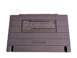 a gray nintendo game console sitting on top of a white table