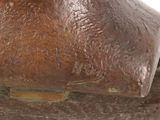bronze sculpture of a man ' s head on a wooden base