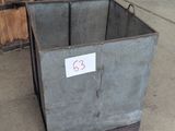 a metal bin with a sign on it in a garage