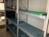 shelves in a kitchen with pots, pans, and pans on them