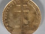 an image of a gold coin with a cross on it