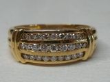 an image of a gold ring with diamonds on a white surface