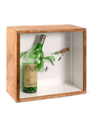a bottle of wine and a cigar in a wooden box