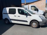 a white van parked in a parking lot next to a building