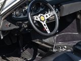 a white sports car with black leather seats and a steering wheel