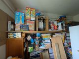 a room with a lot of boxes and toys on the shelves