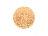 a gold coin with a picture of a rooster on it