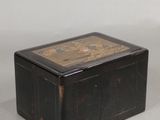 a black box with a painting on it on a table