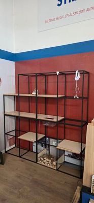 a man that is standing in front of a shelf