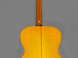 a yellow acoustic guitar on a gray background