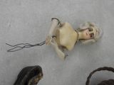 a doll that is laying on the floor next to a basket