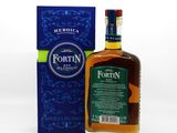 a bottle of fortin whisky next to a blue box