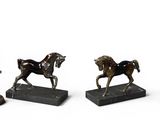 three bronze figurines of a horse and a man with a top hat