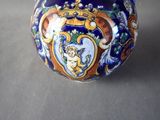 a blue and white vase with a picture of a cat on it