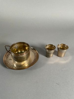 two cups and a saucer sitting on a table