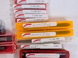 many different types of pens and pencils on the table