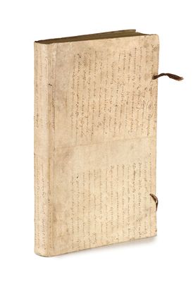an old book with writing on it sitting on top of a white surface
