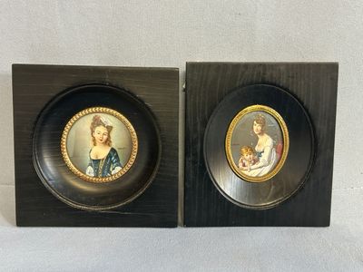 pair of framed miniature portraits of a lady and a cat