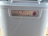 a small plastic container with a button on it