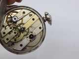 a close up of a pocket watch being held by a person