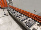 an image of a conveyor belt in a factory with a machine in the background