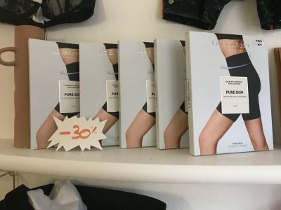 many boxes of underwear on a shelf in a store