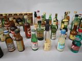 many bottles of alcohol sitting next to each other on a table