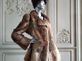a mannequin dressed in a fur coat and hat