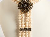 pearl necklace with black and white flowers and pearls on a mannequin