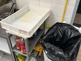 a trash can sitting next to a trash can in a bathroom