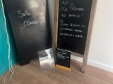 two chalk boards that are next to each other on the floor