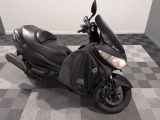 a black motorcycle parked in a room with a checkered floor