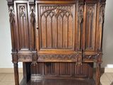 a wooden cabinet with a mirror on top of it