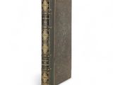 an old book sitting on top of a white surface
